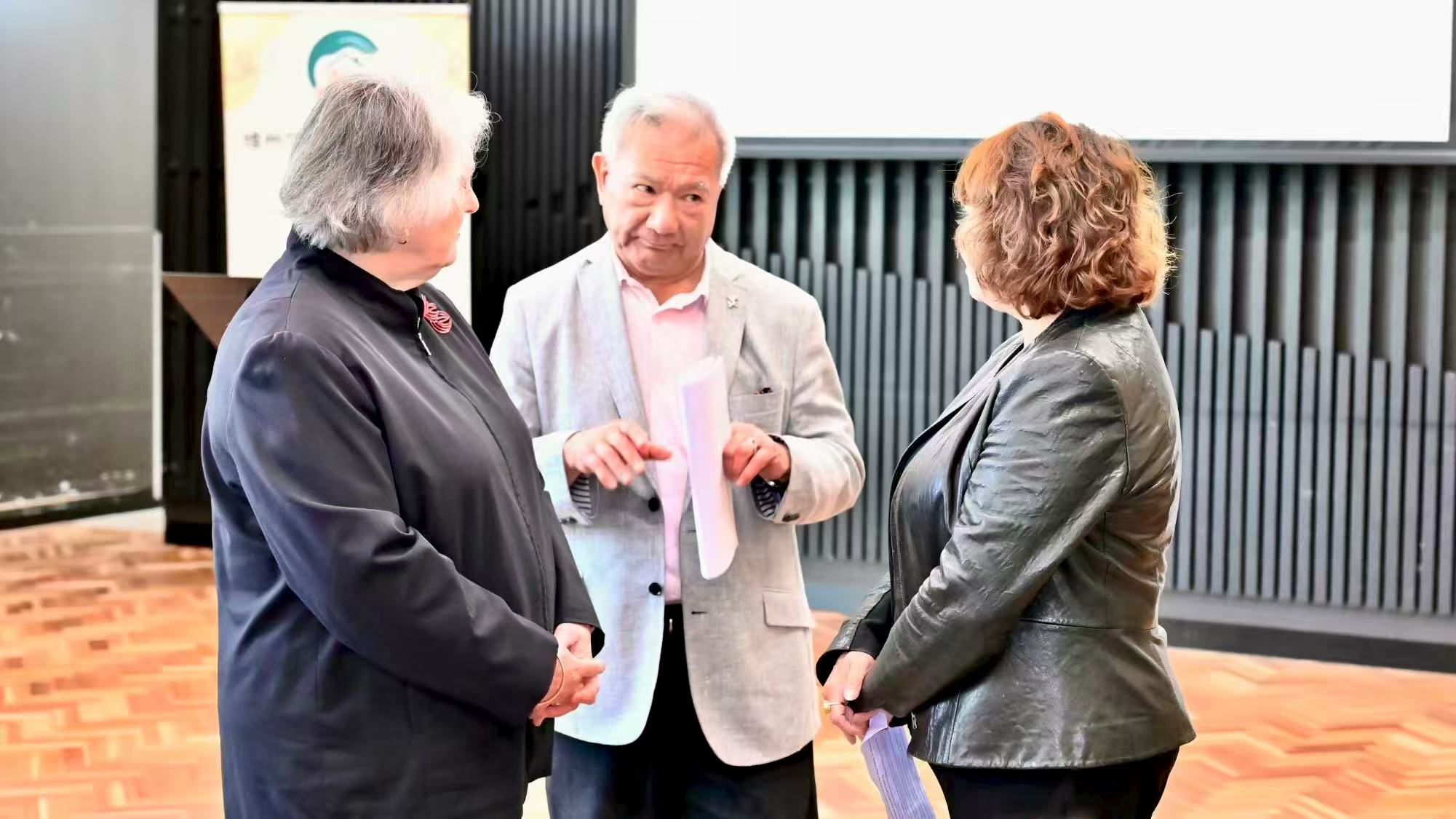 Three guests talking together inside the venue