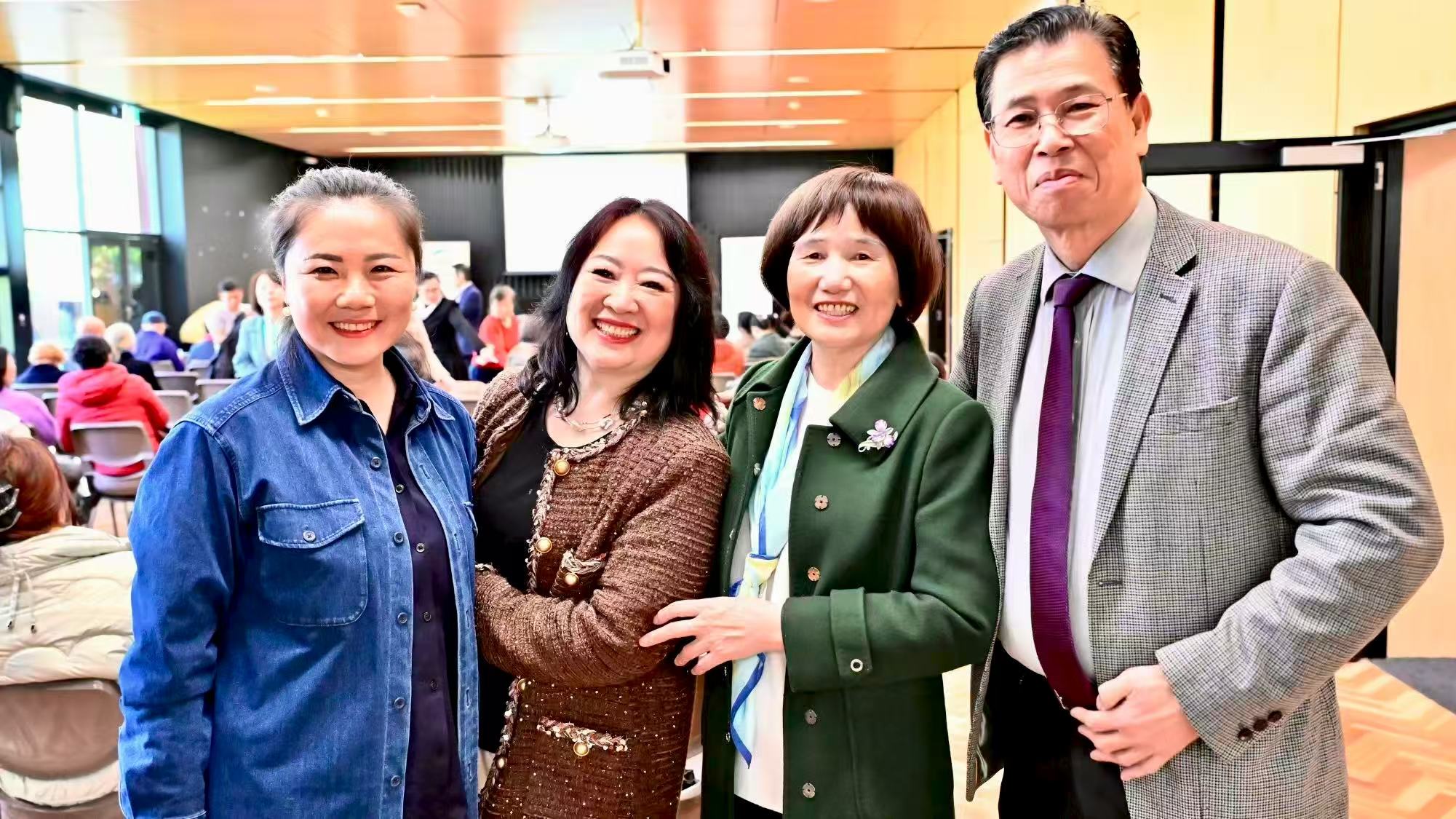 Four guests posing for a photograph at the event