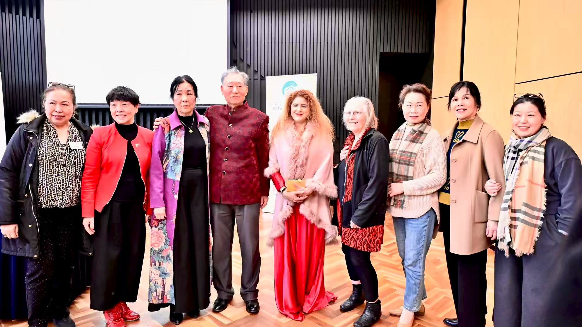 Guests posing together in front of the organisation’s display