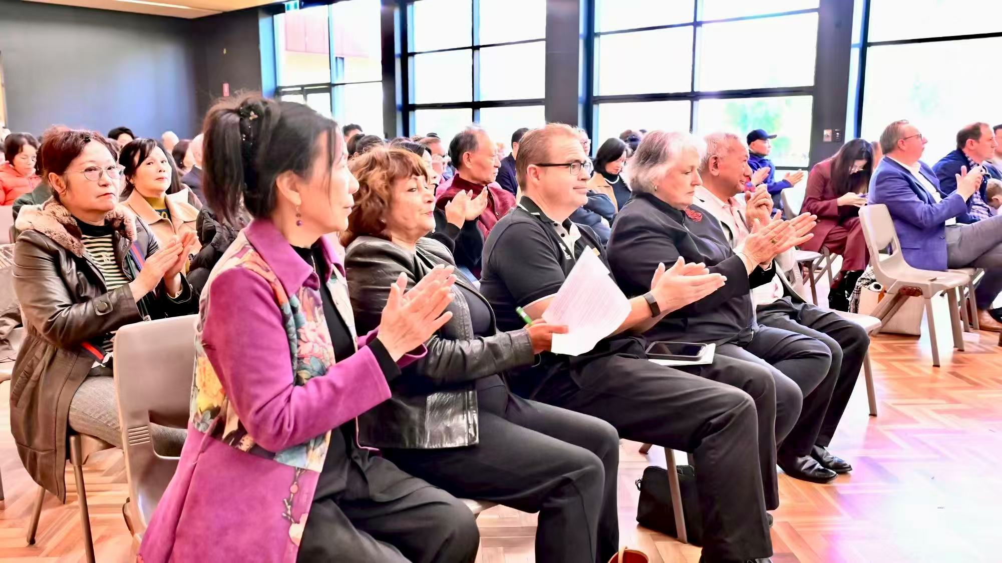 Guests seated in the audience applauding during the launch ceremony