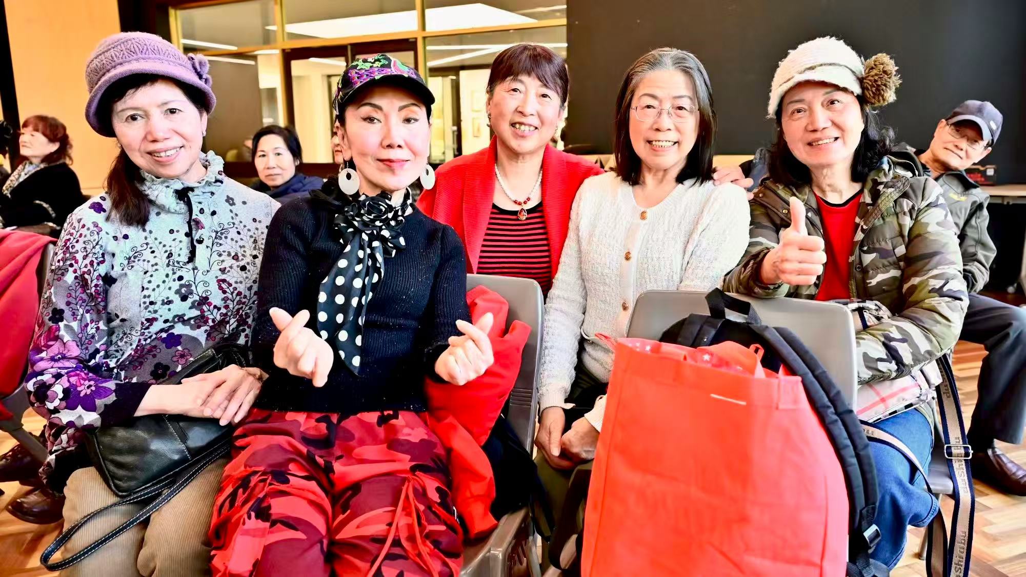 Several guests posing for a photograph in the audience